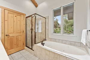 Bathroom with a shower stall, a bath, plenty of natural light, tile patterned flooring, and beam ceiling