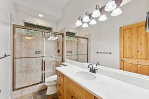 Bathroom featuring vanity and a shower stall