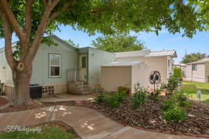 View of front of home featuring a shed and a patio