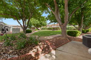 View of grassy yard featuring a patio and a gazebo