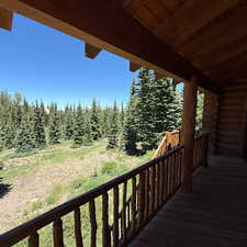 Wooden terrace featuring a forest view