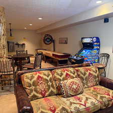 Carpeted living room with a textured ceiling and recessed lighting