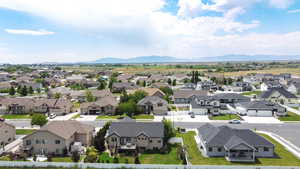 Aerial perspective of suburban area featuring a mountainous background