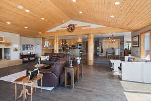 Living room featuring lofted ceiling, recessed lighting, wooden ceiling, wood finished floors, and a chandelier