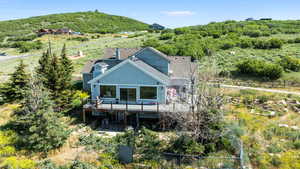 Back of house with a deck with mountain view