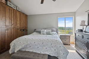 Bedroom featuring light carpet and a ceiling fan