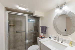 Bathroom featuring vanity and a shower stall