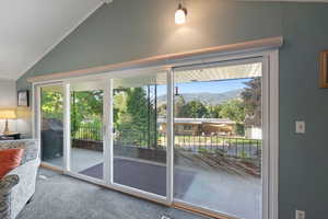 Balcony featuring covered deck, a mountain view, plenty of natural light and ornamental molding.