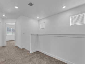 Hallway featuring carpet and recessed lighting