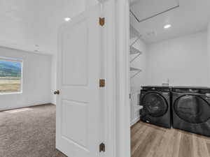 Laundry area featuring washing machine and dryer and attic access