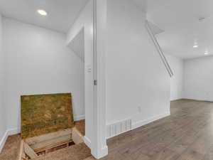 Bonus room with wood finished floors and recessed lighting