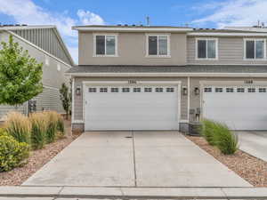 Traditional-style house with concrete driveway and an attached garage