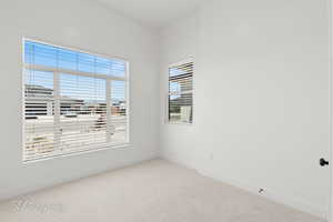 Empty room featuring carpet floors and baseboards