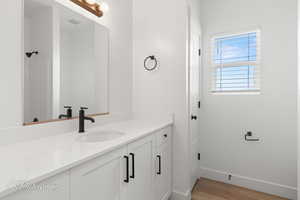 Bathroom with vanity and wood finished floors