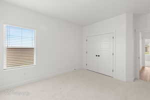 Unfurnished bedroom with carpet floors and a closet