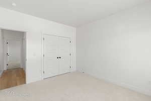 Unfurnished bedroom with carpet floors and a closet