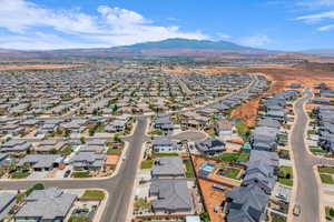 Aerial view of property and surrounding area featuring nearby suburban area