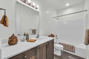 Full bathroom featuring vanity, bathtub / shower combination, and wood finished floors