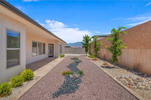 Fenced backyard featuring a mountain view and a patio
