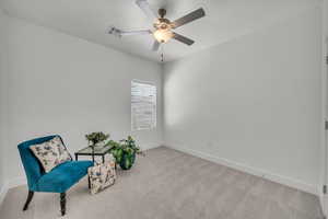 Unfurnished room with light colored carpet and ceiling fan