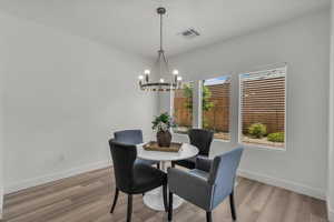 Dining space featuring a chandelier and light wood-style flooring