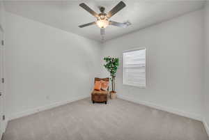 Sitting room featuring carpet flooring and ceiling fan