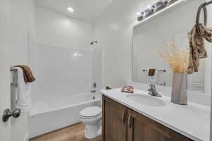 Full bathroom featuring vanity, wood finished floors, and bathing tub / shower combination