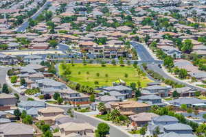 Aerial perspective of suburban area featuring a golf course