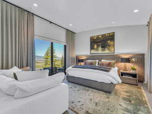 Bedroom with recessed lighting, access to outside, a mountain view, and wood finished floors
