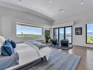 Bedroom with recessed lighting, access to outside, wood finished floors, a mountain view, and vaulted ceiling