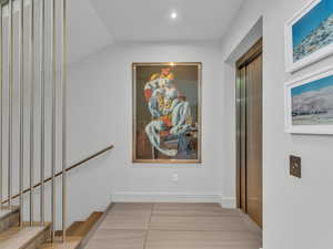 Hall featuring recessed lighting, elevator, stairway, and light tile patterned flooring