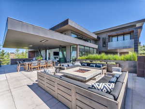 View of patio / terrace with an outdoor living space with a fire pit and outdoor dining space