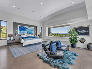 Bedroom featuring multiple windows, recessed lighting, wood finished floors, and vaulted ceiling