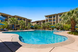 Community pool with a patio