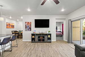 Living room featuring light wood-style floors, recessed lighting, and a ceiling fan