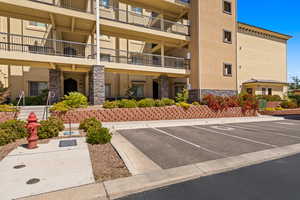 View of property with uncovered parking