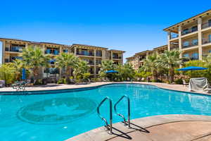 Community pool featuring area for grilling