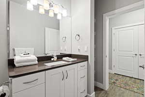 Bathroom featuring vanity and wood finished floors