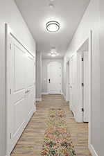 Hallway featuring a textured ceiling and light wood-type flooring