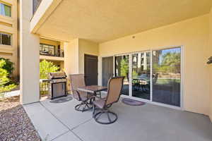 View of patio with a grill and outdoor dining space