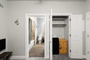 Bedroom with a closet and baseboards