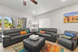 Living area featuring wood finished floors, recessed lighting, and a ceiling fan