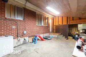 Basement featuring brick wall