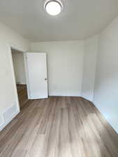 Empty room featuring light wood-style floors and baseboards