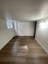 Below grade area featuring dark wood-type flooring and baseboards