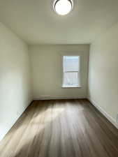 Unfurnished room with light wood-style flooring and baseboards