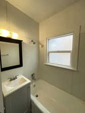 Bathroom featuring vanity and shower / tub combination
