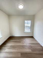 Unfurnished room featuring baseboards and light wood-style floors