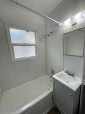 Bathroom featuring vanity and shower / tub combination