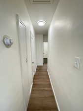 Hall featuring baseboards and dark wood finished floors